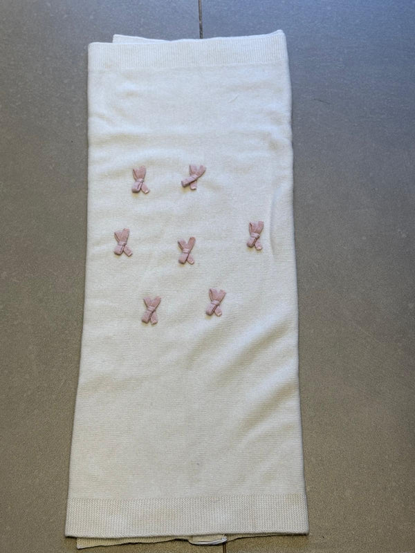 Coperta in lana panna con fiocchetti rosa