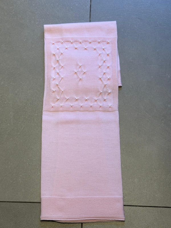 Coperta in lana rosa con punto smock